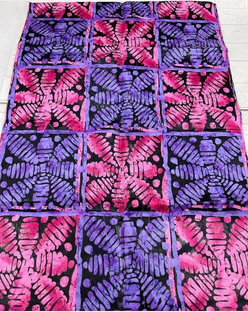 Adire Brocade fabric with pink and purple starburst squares on black