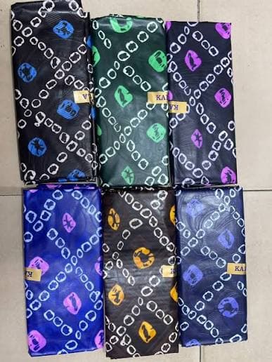 Six folded Kampala Adire pieces with chain-link circles in different colours