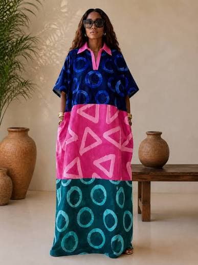 Woman wearing a navy, pink and teal colour-block Adire maxi kaftan